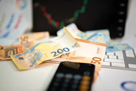 A cell phone sitting on top of a pile of money