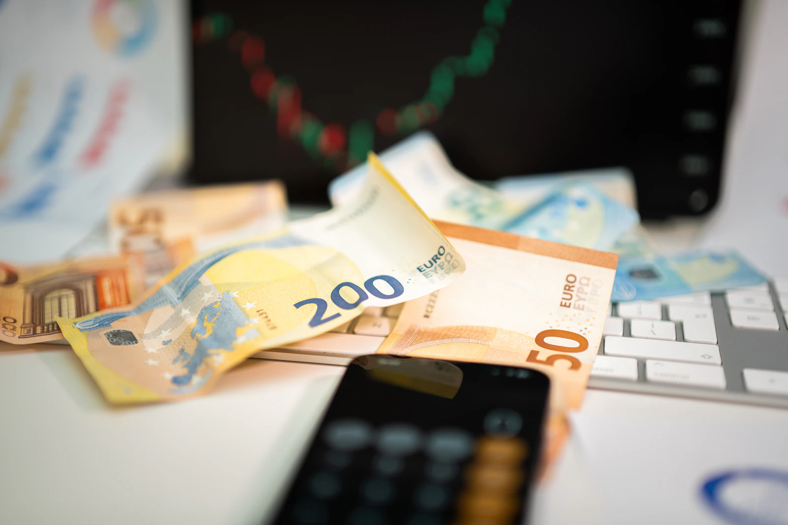 Phone on top of a pile of money, mobile earnings