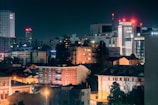 A city skyline at night with buildings lit up