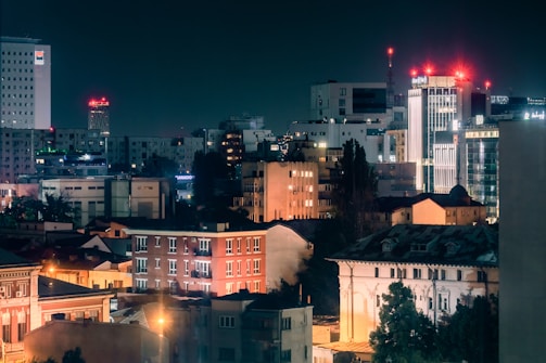 A city skyline at night with buildings lit up