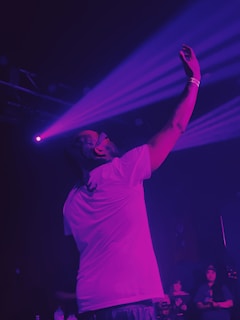 A man standing on a stage holding a microphone