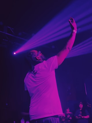 A man standing on a stage holding a microphone