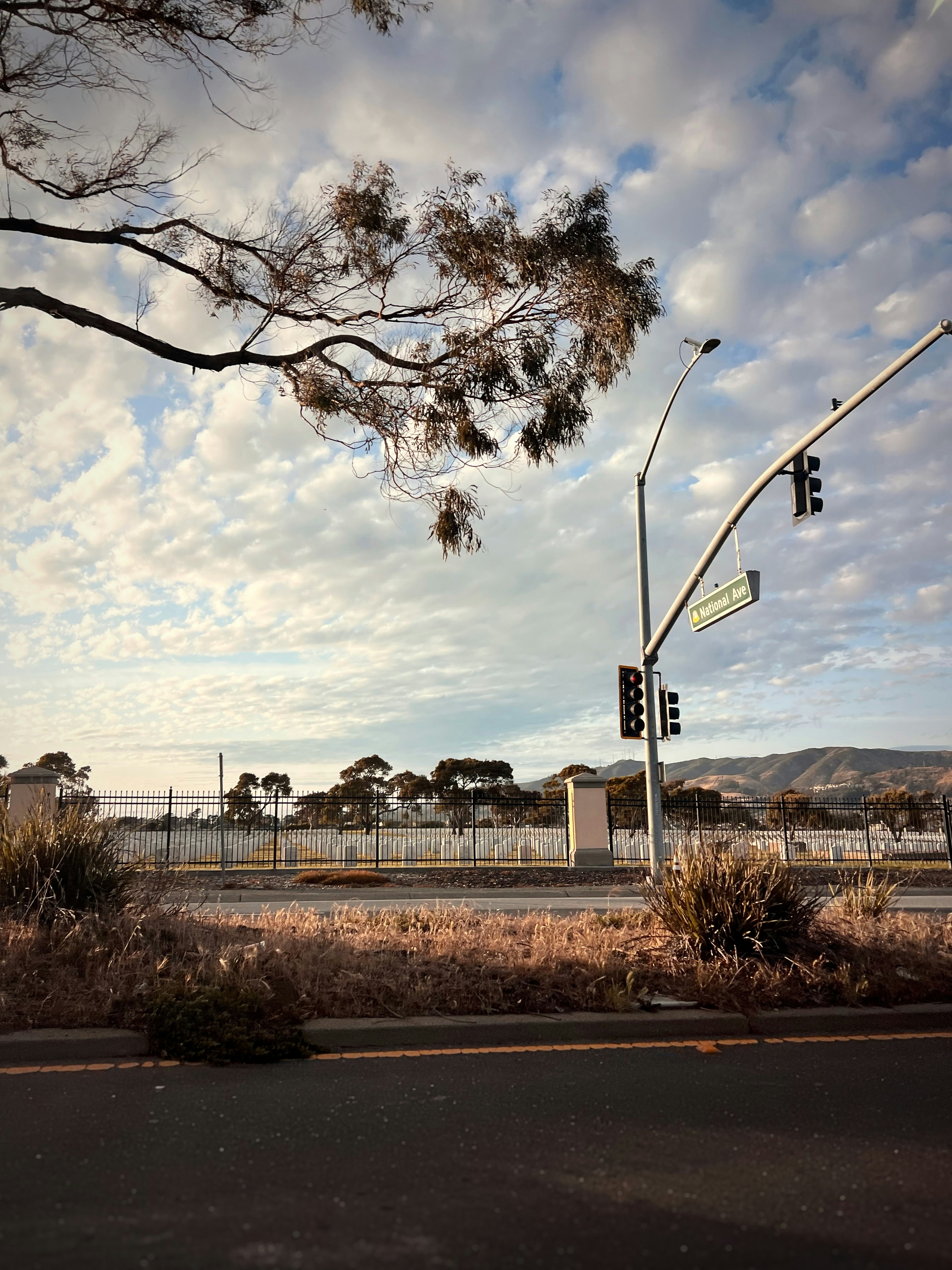A stop light on a street corner with a sky background