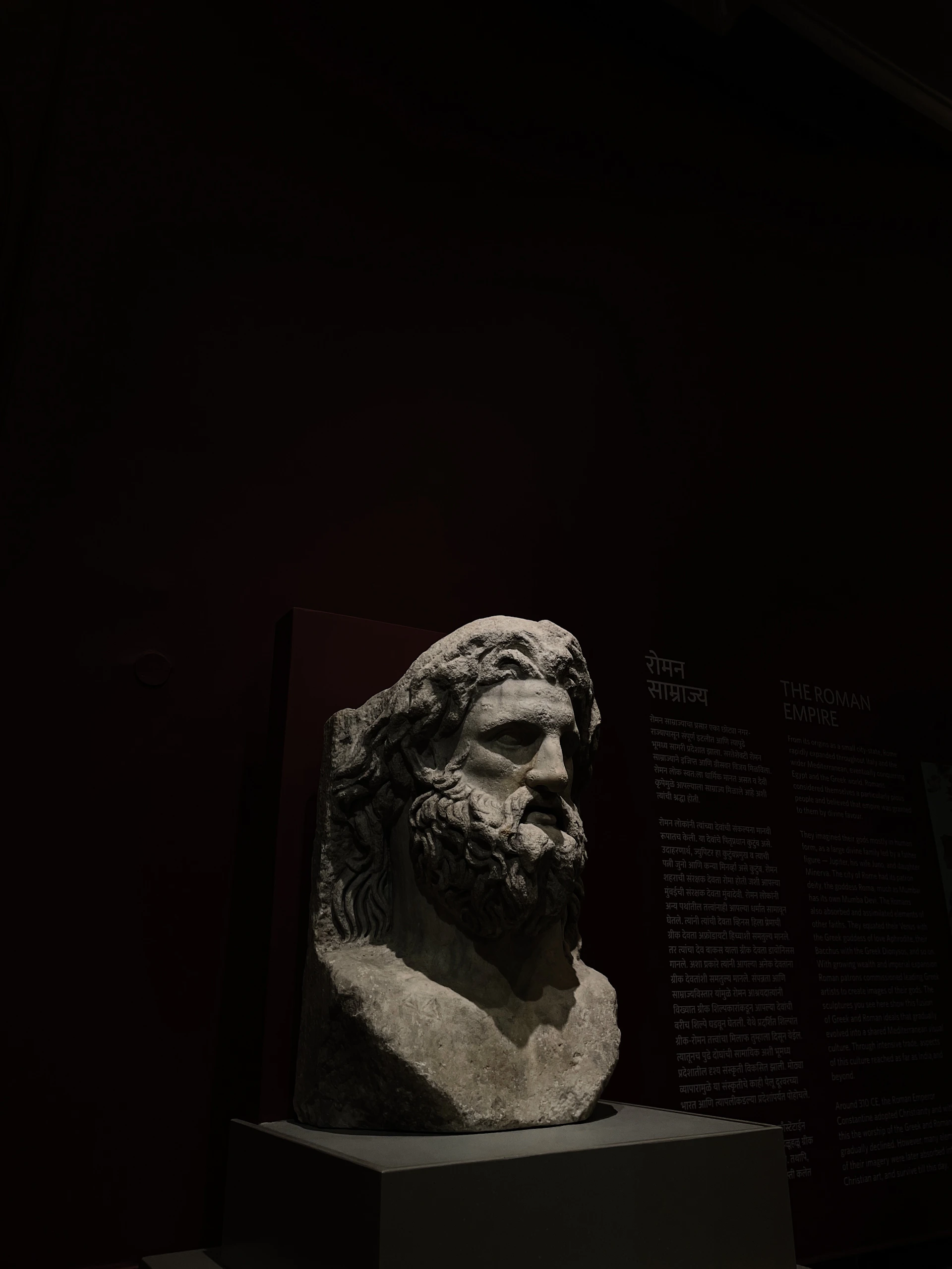 A bust of a man in a dark room