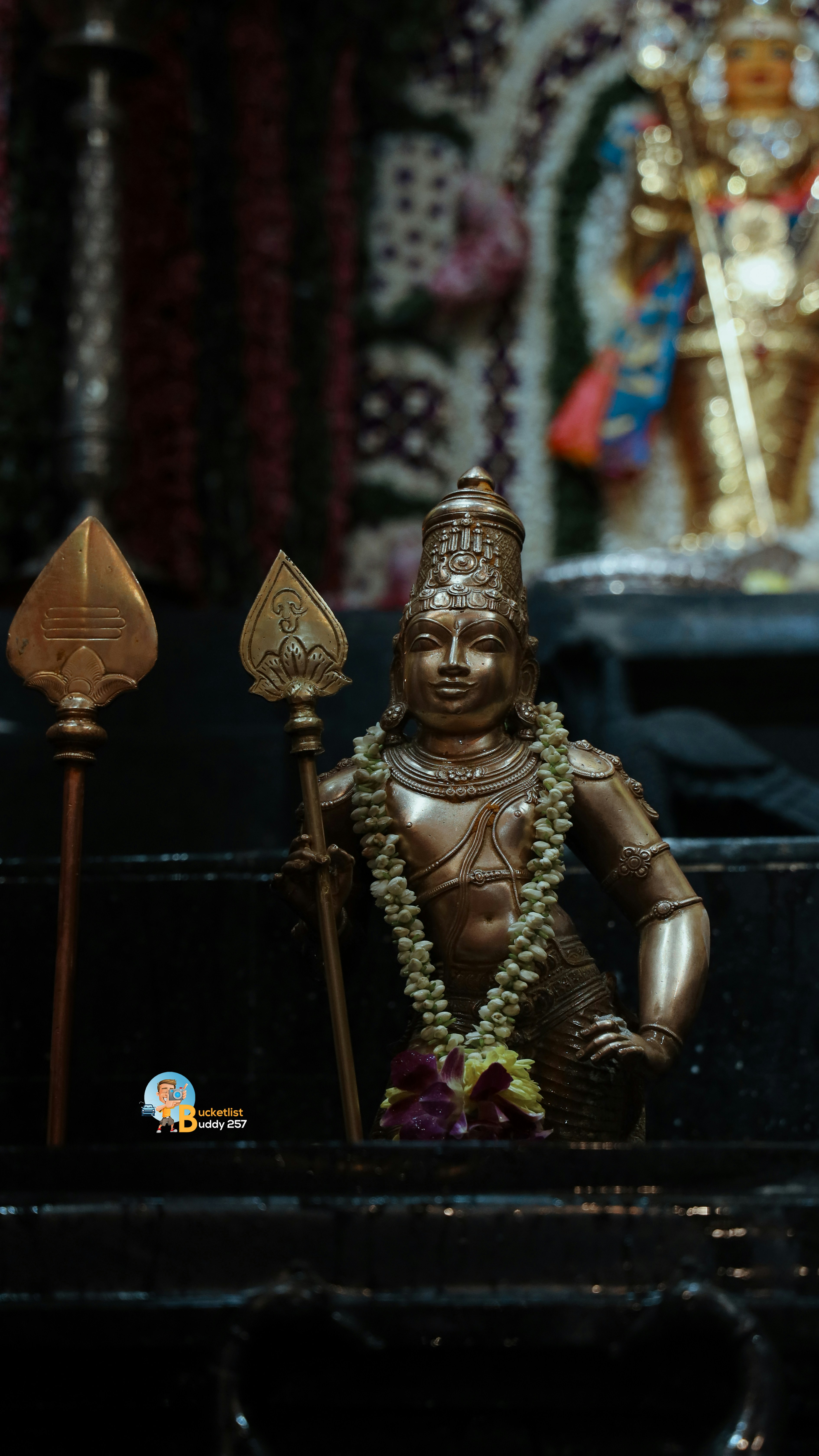 A statue of a person sitting in front of a shrine