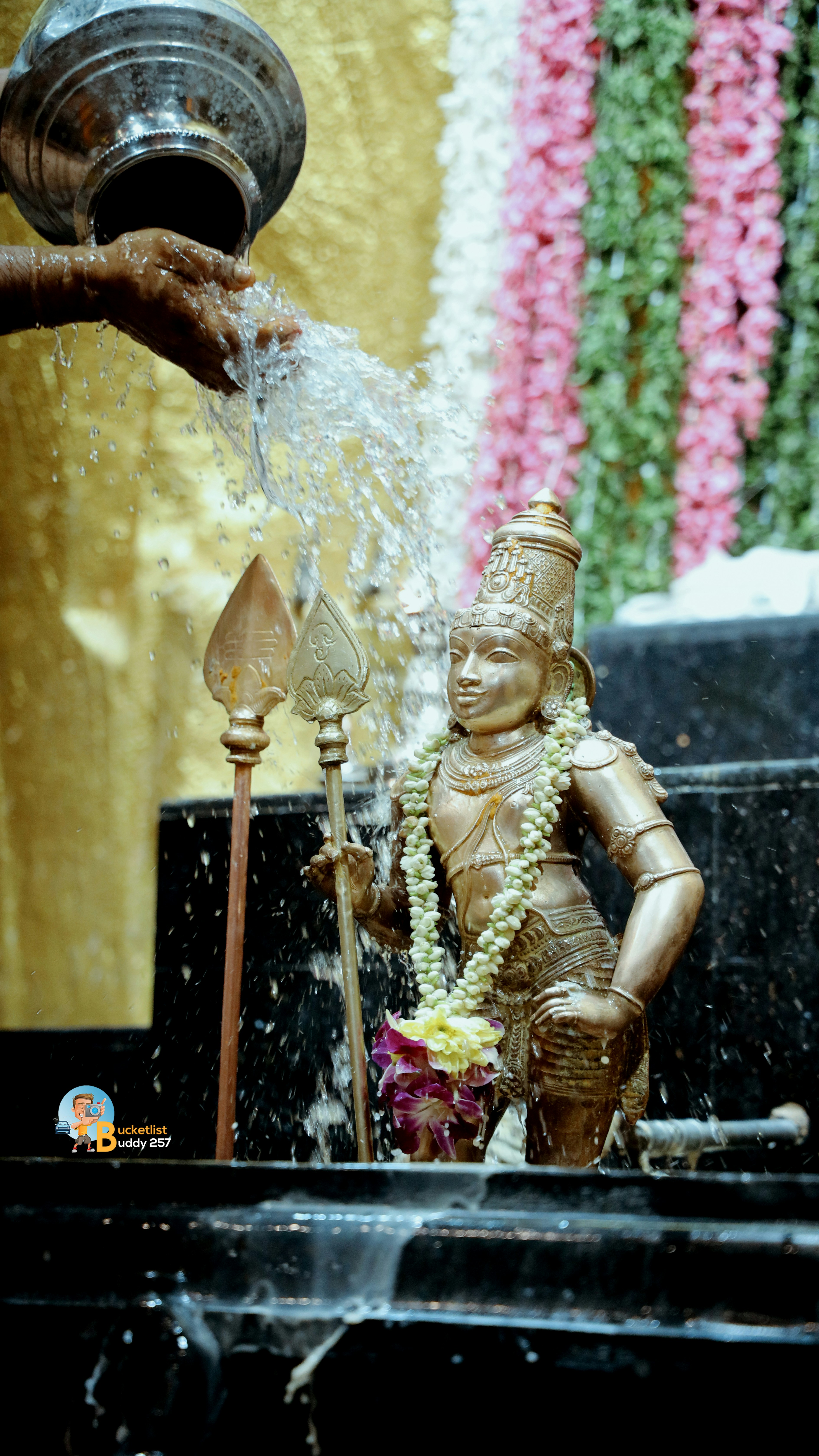 A statue of a person pouring water from a faucet