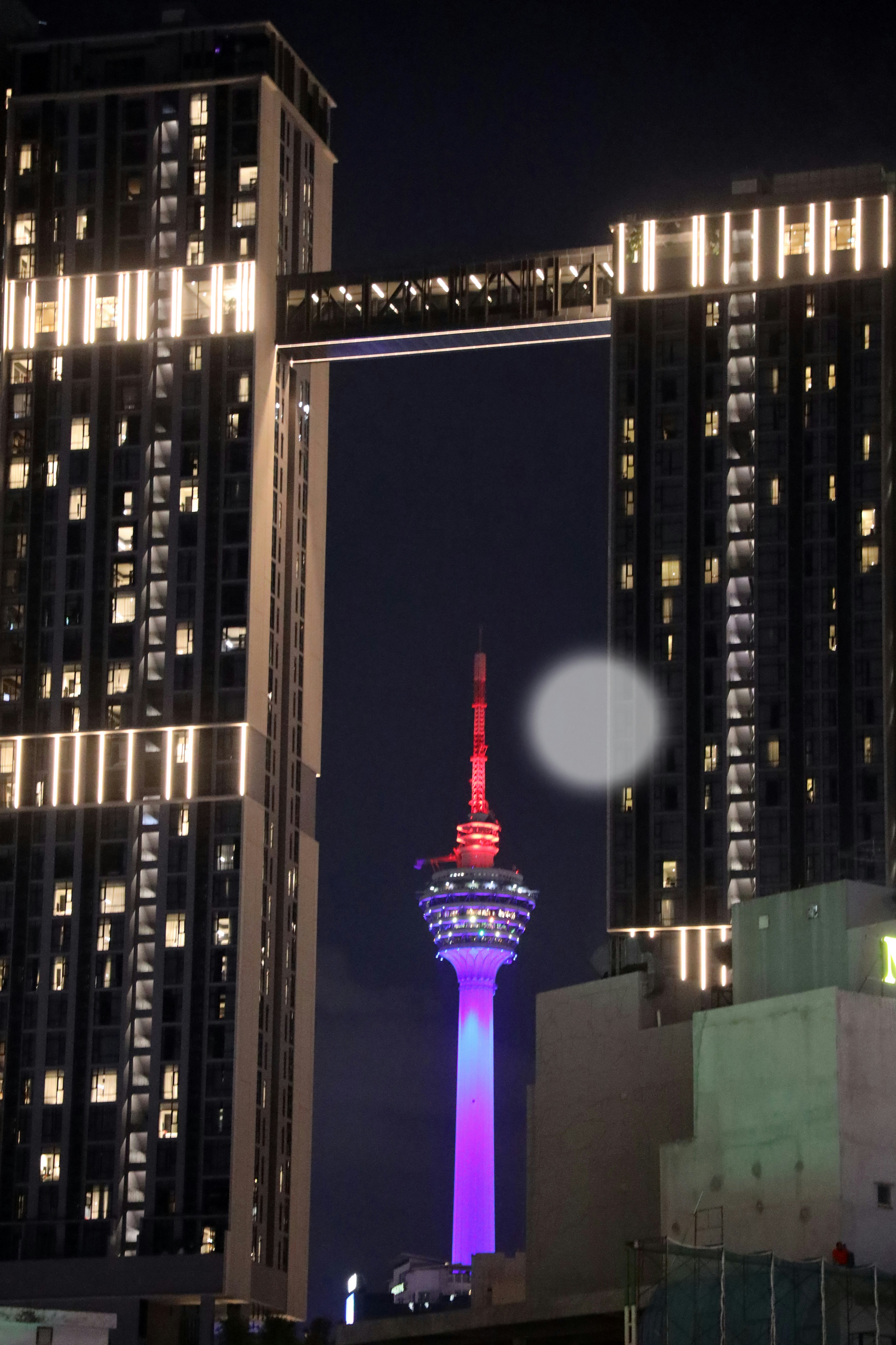 A tall building with a tower lit up at night