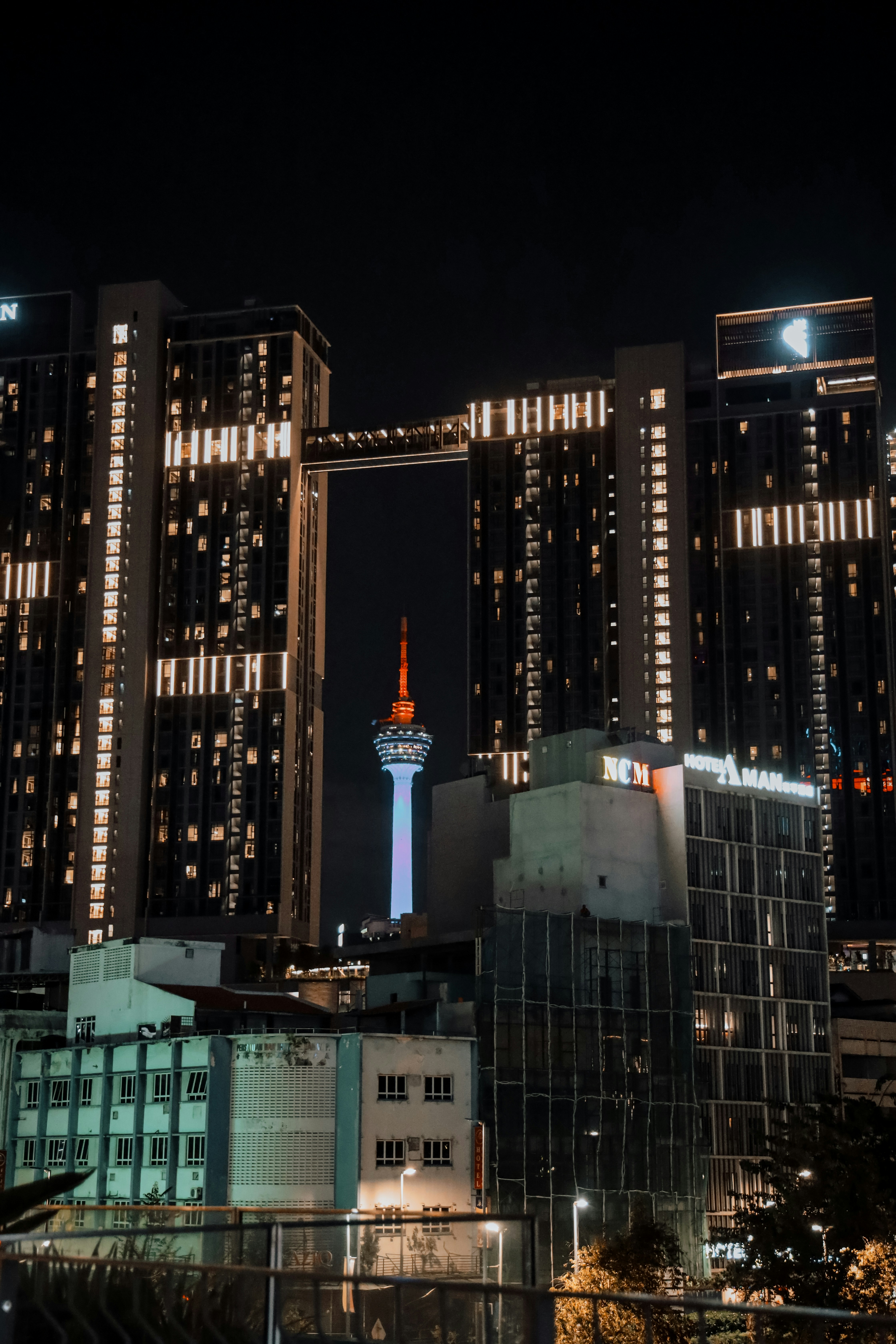 A city at night with tall buildings lit up