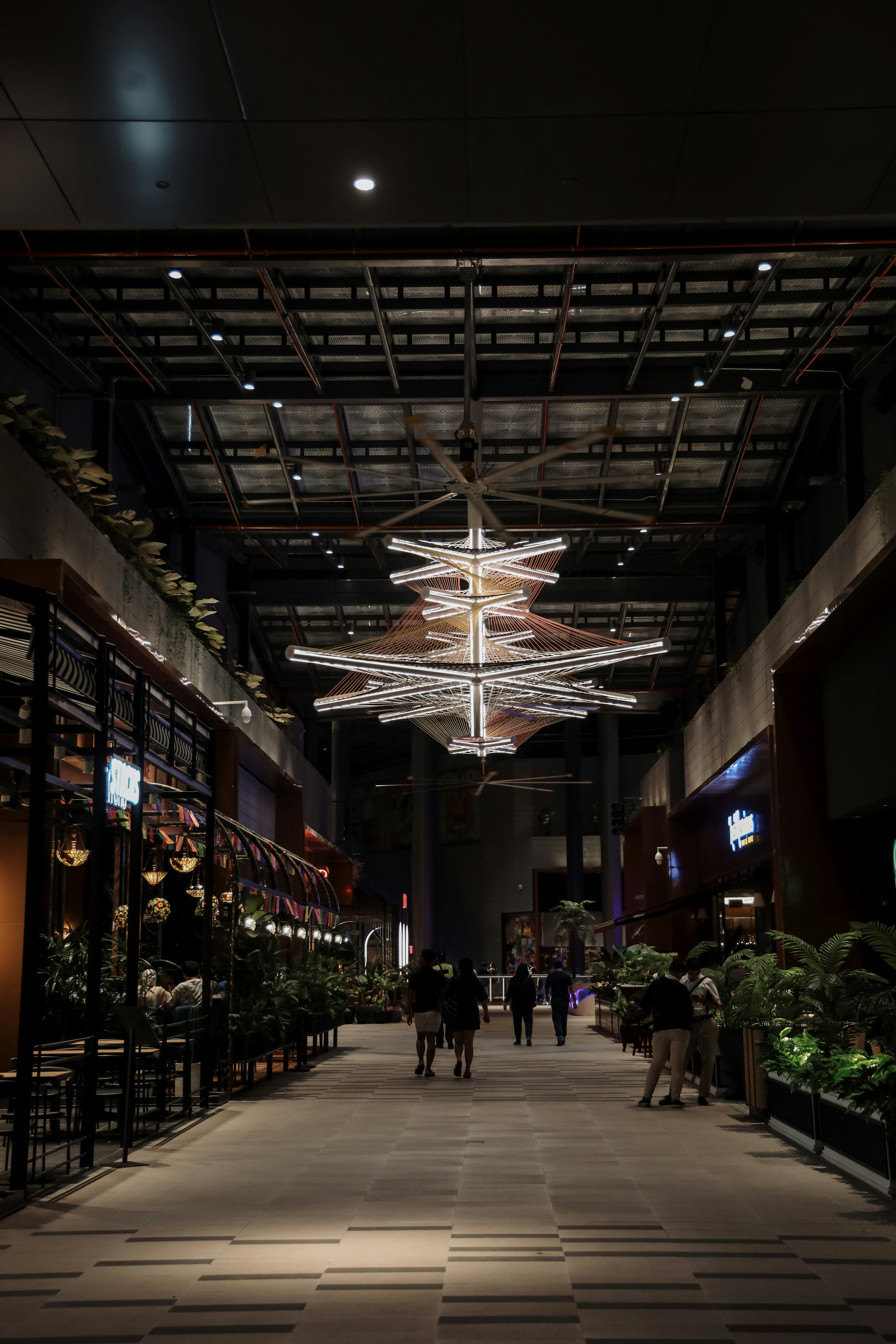A group of people walking inside of a building