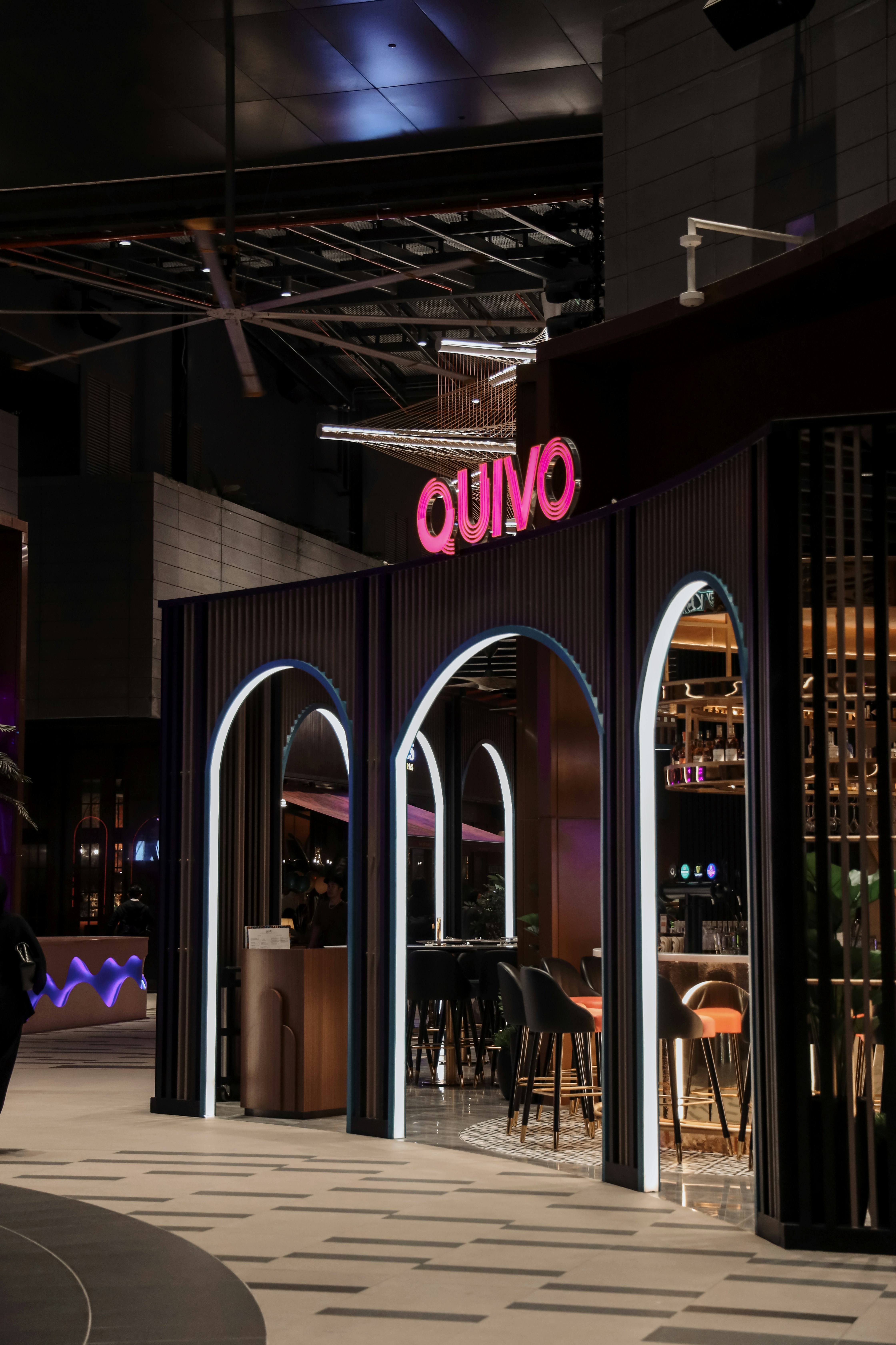 A man walking down a street next to a building