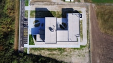 An aerial view of a house in the middle of a field
