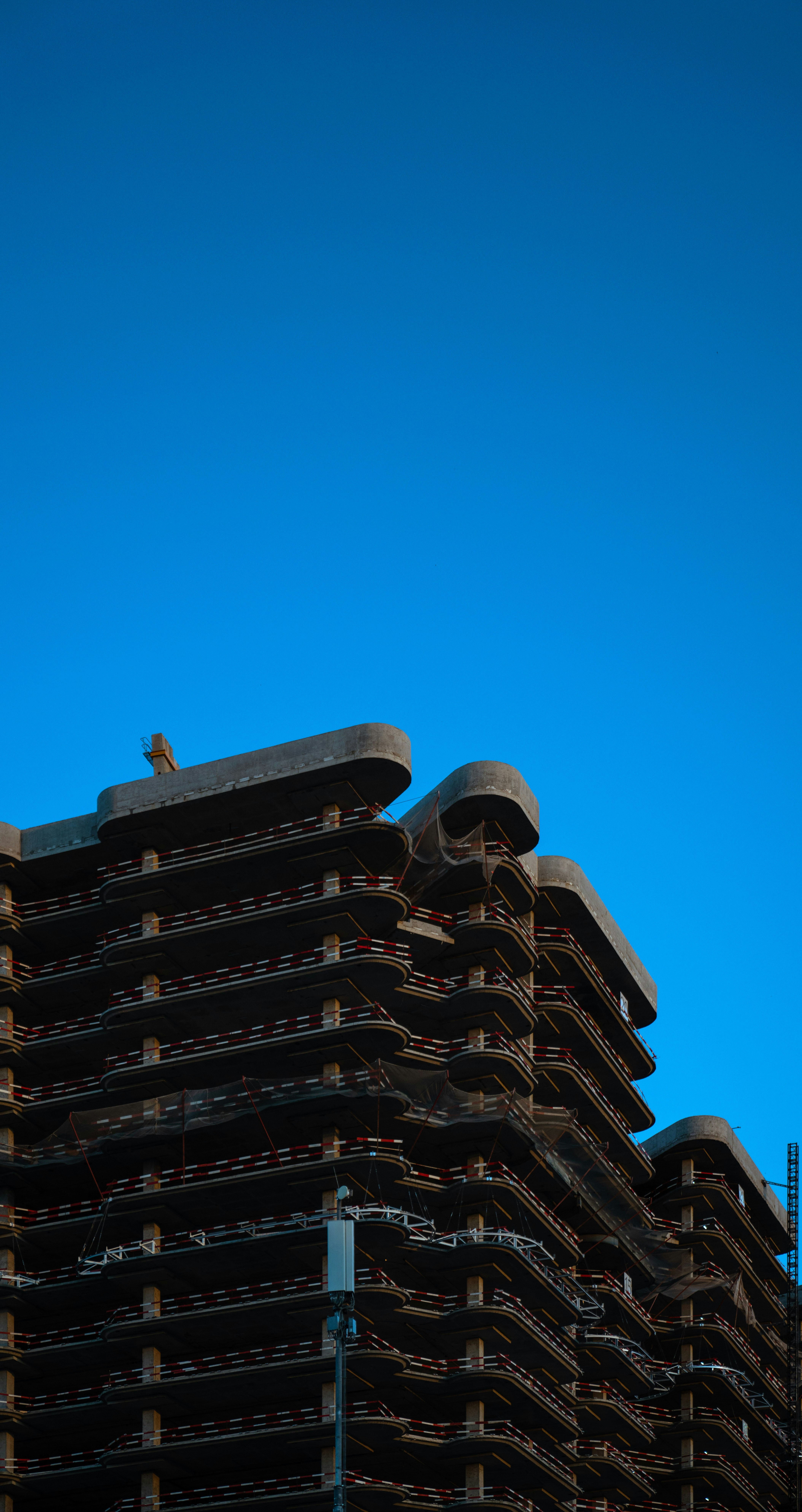 A very tall building with a clock on it's side photo – Free Building ...