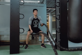 A man in a gym with a punching bag