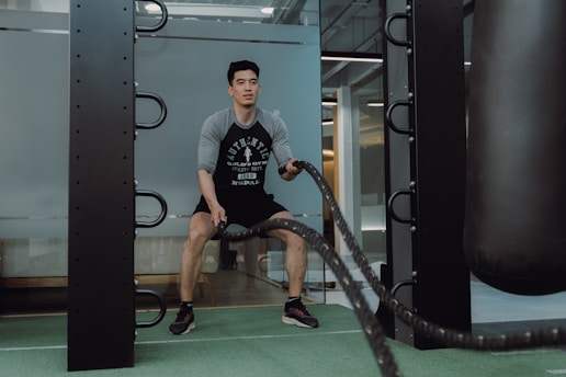 A man in a gym with a punching bag