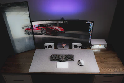 A computer desk with a monitor and keyboard