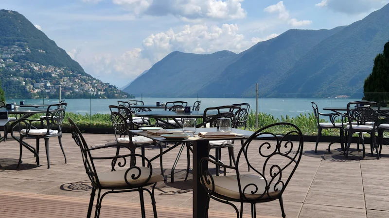 Terrace tables looking across still water to the mountains