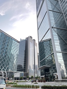 A bus driving down a street next to tall buildings