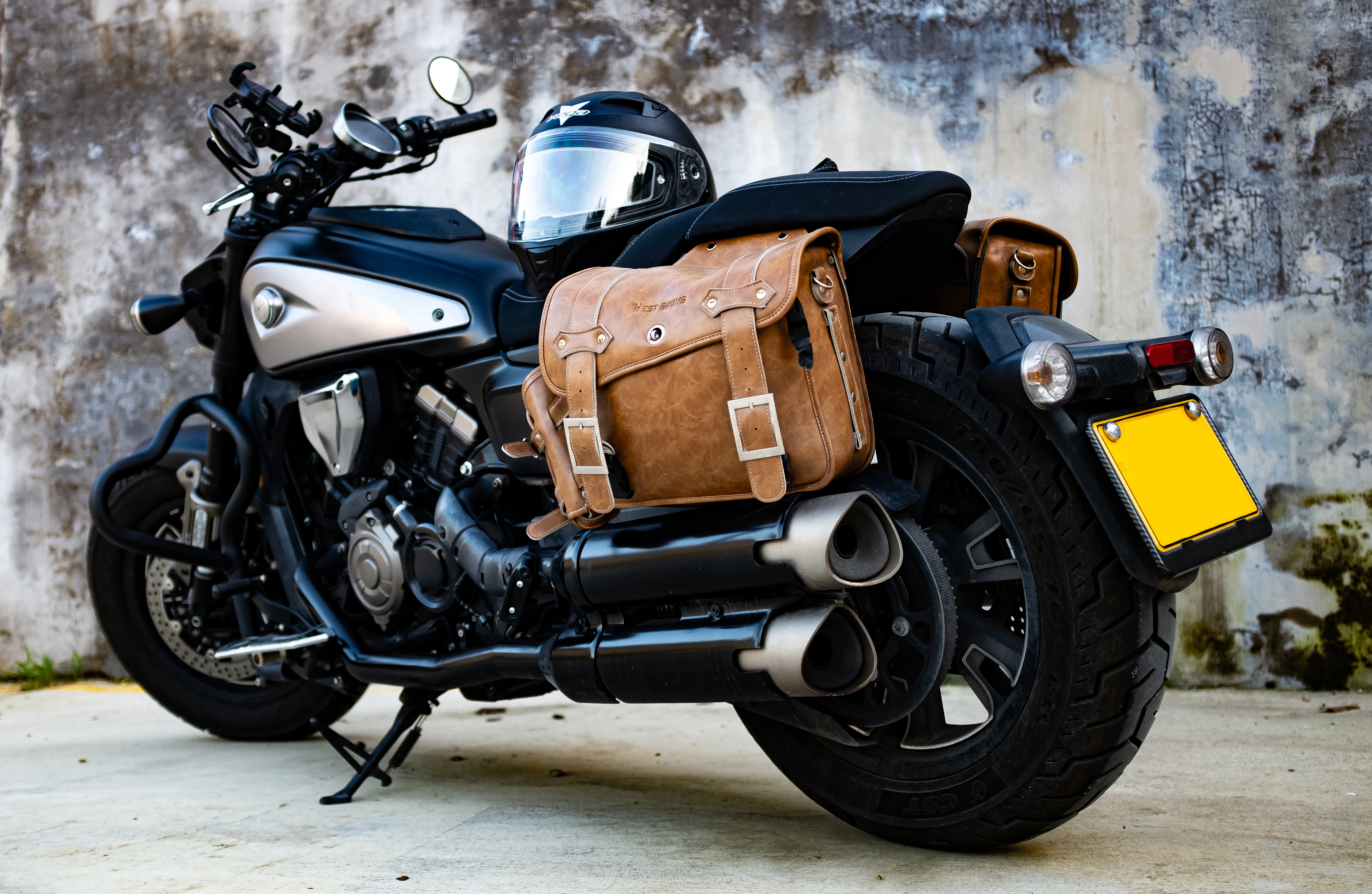 Tan leather saddlebag fitted to the side of a black cruiser