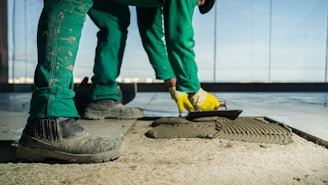 A person in green pants and yellow shoes