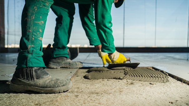 A person in green pants and yellow shoes