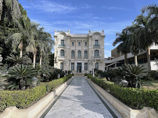 A large white building with a long driveway in front of it