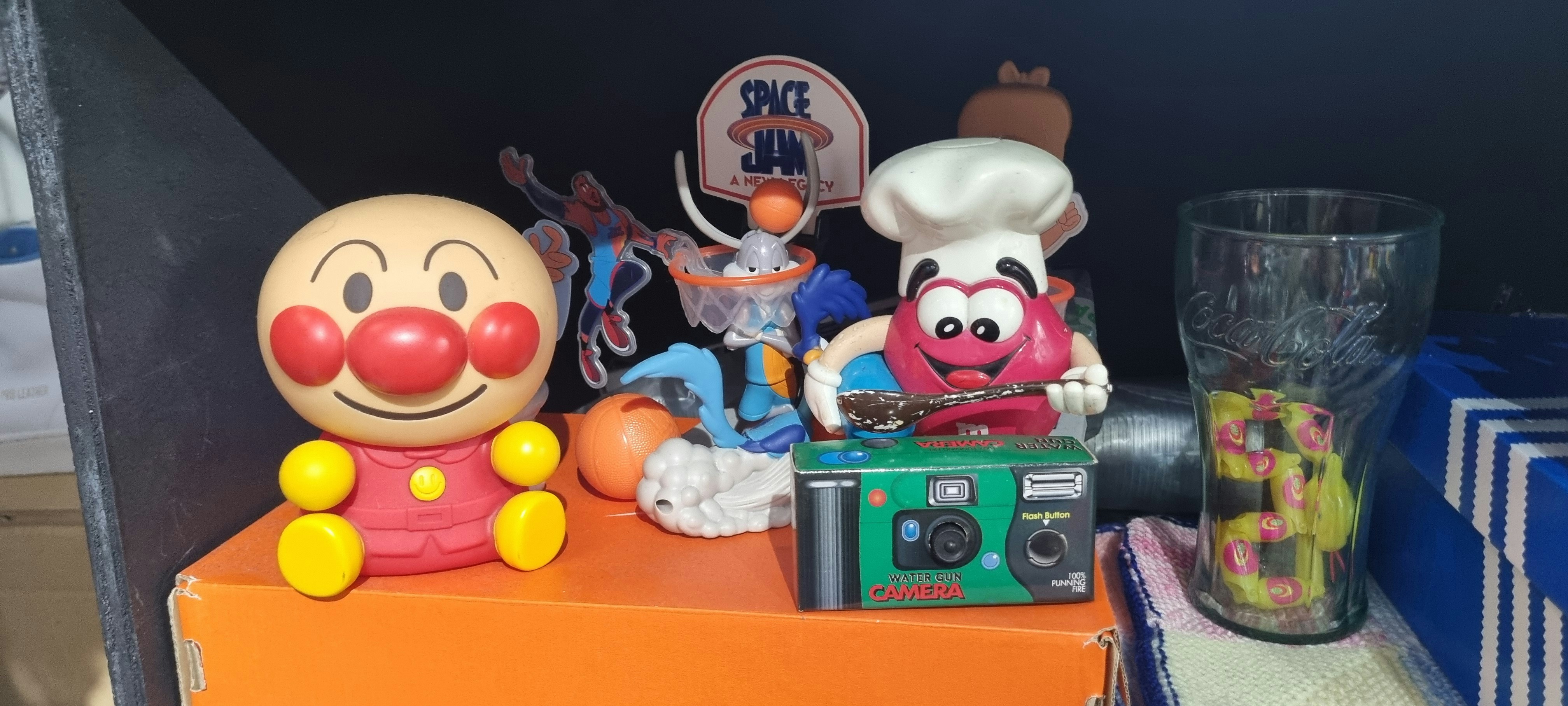 A bunch of toys that are on a shelf