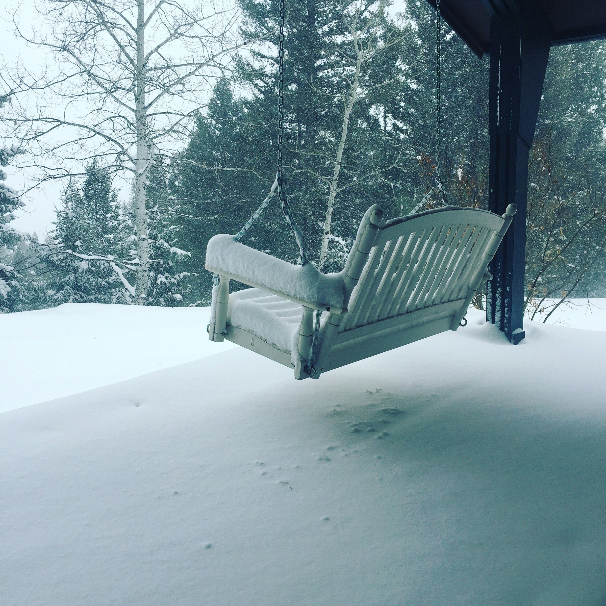 A bench sitting on top of a snow covered field