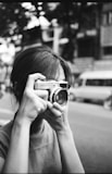 A woman taking a picture with a camera