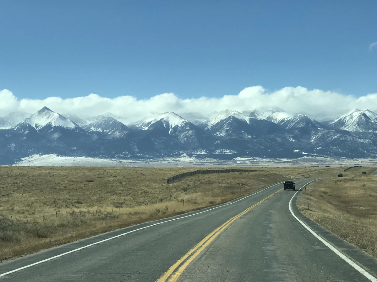 Driver on a Colorado road with affordable car insurance