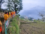 A long line of people walking up a hill