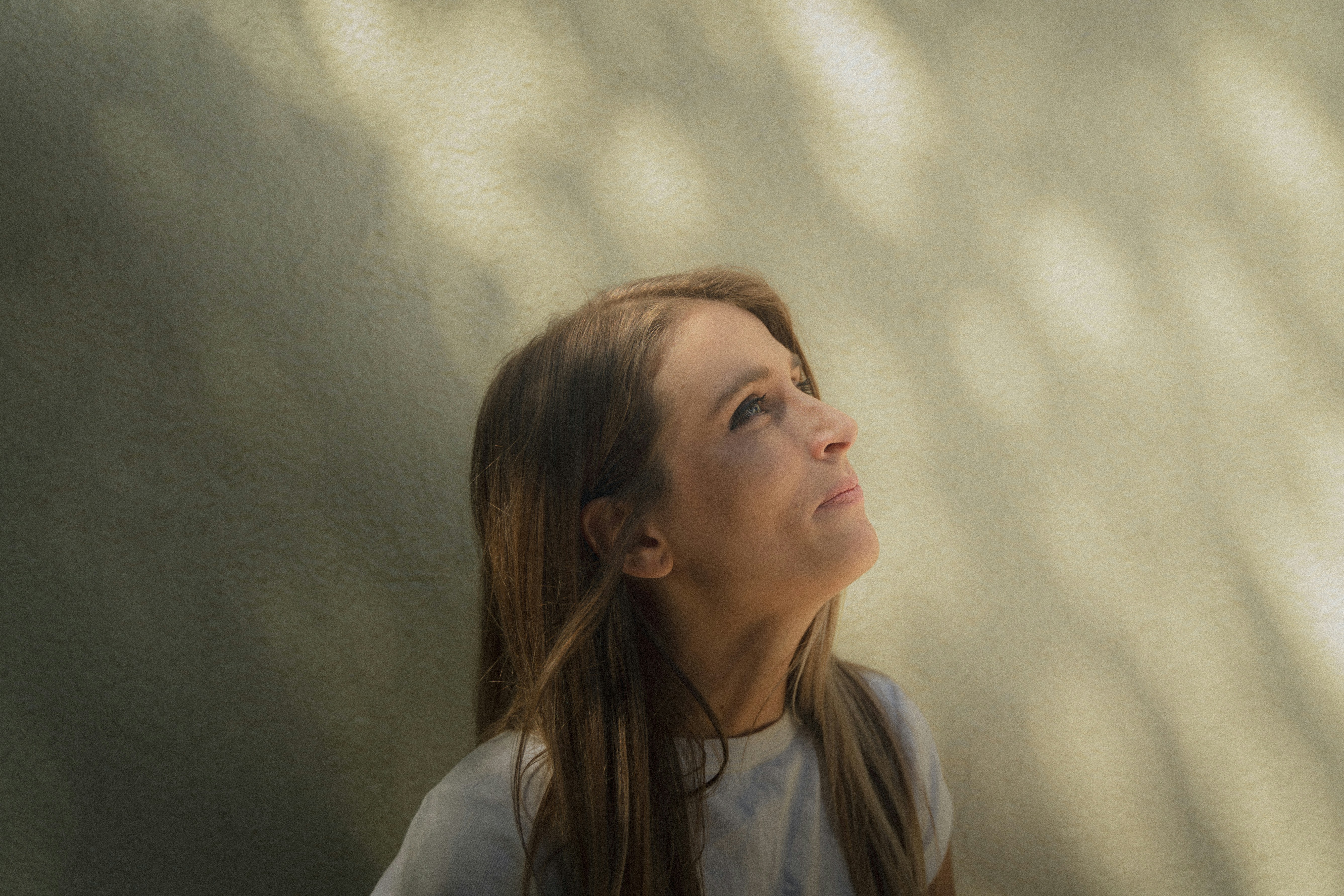 A woman with long hair looking up into the sky