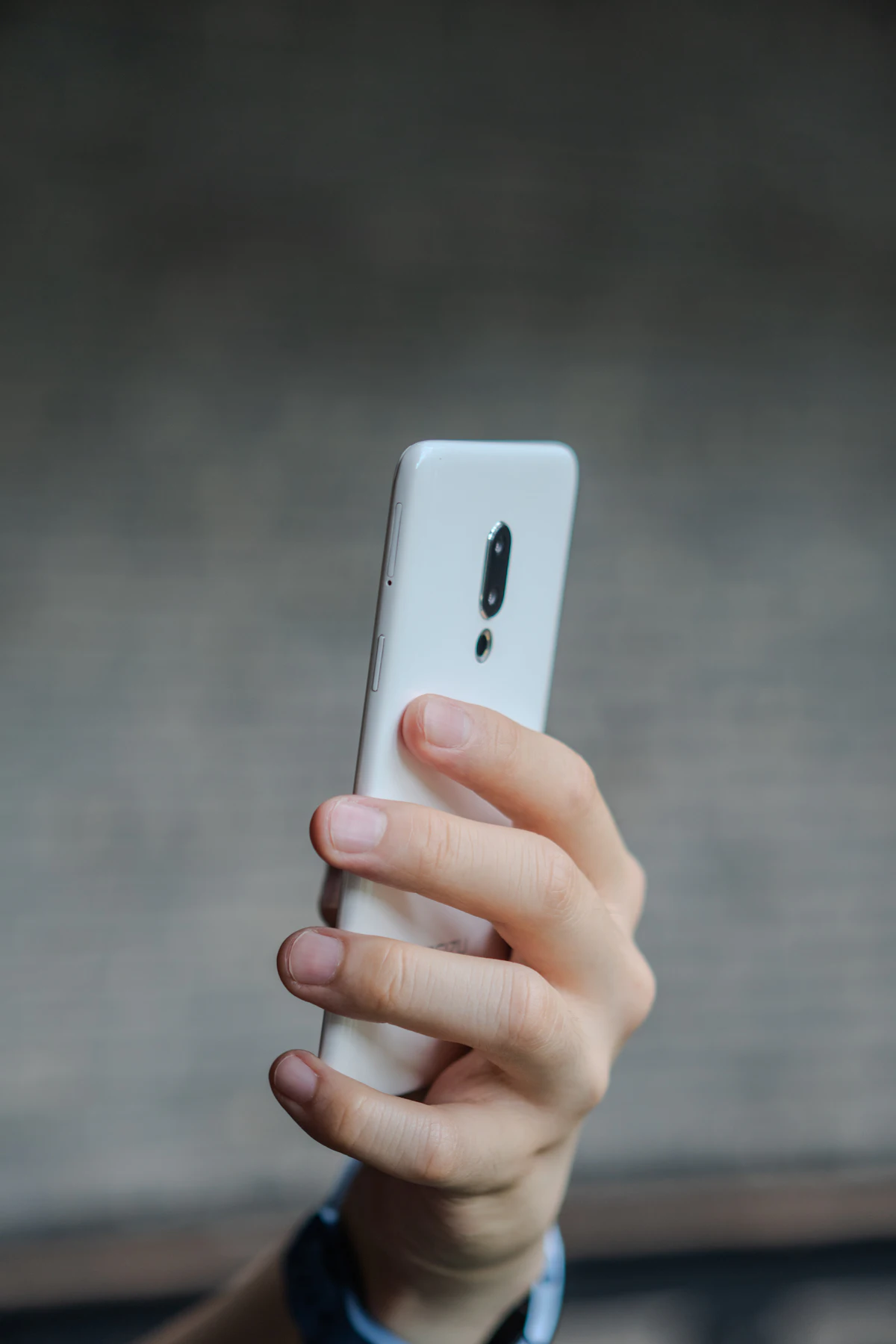 A person holding and using a smartphone close up