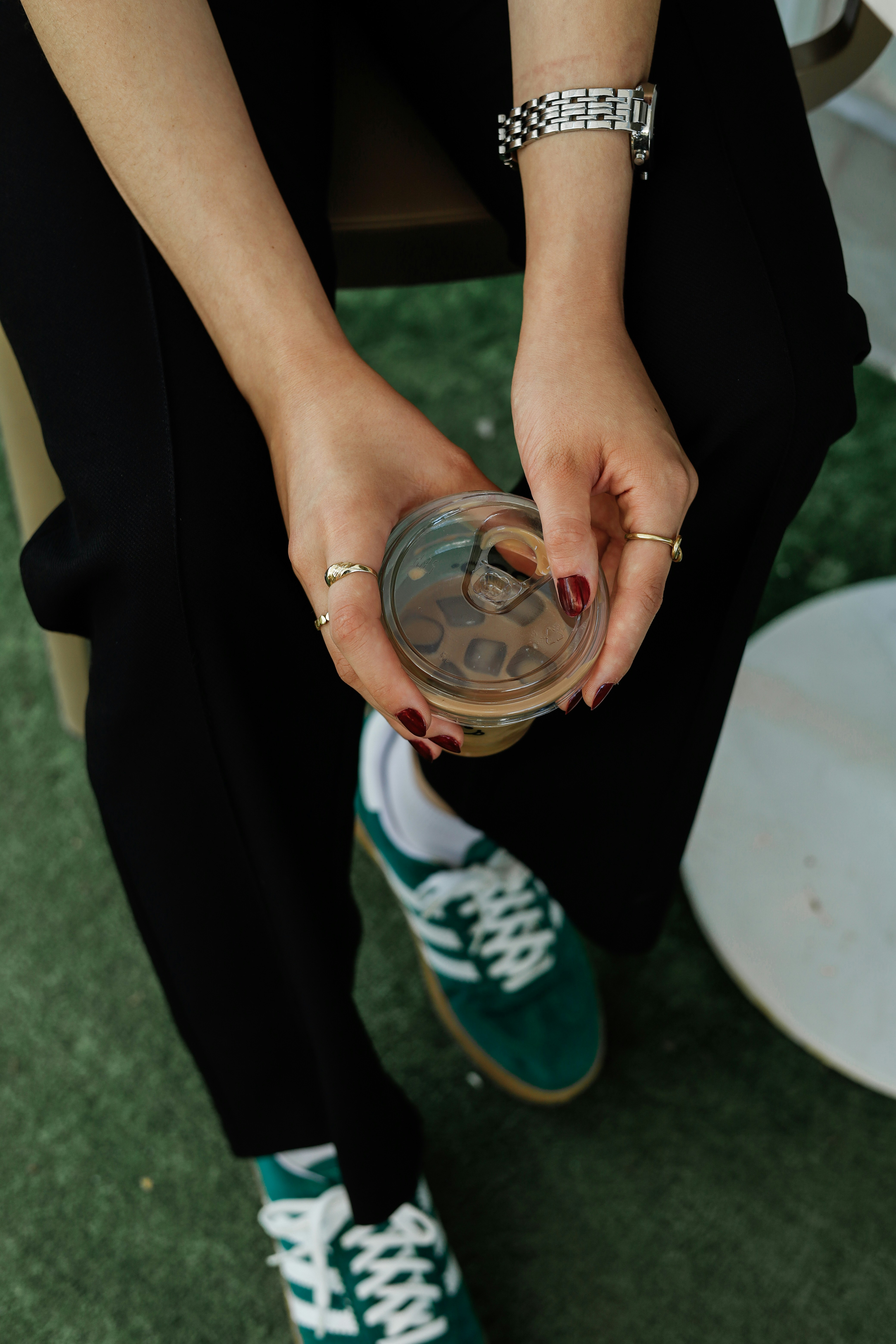 A person sitting on a chair holding a cup