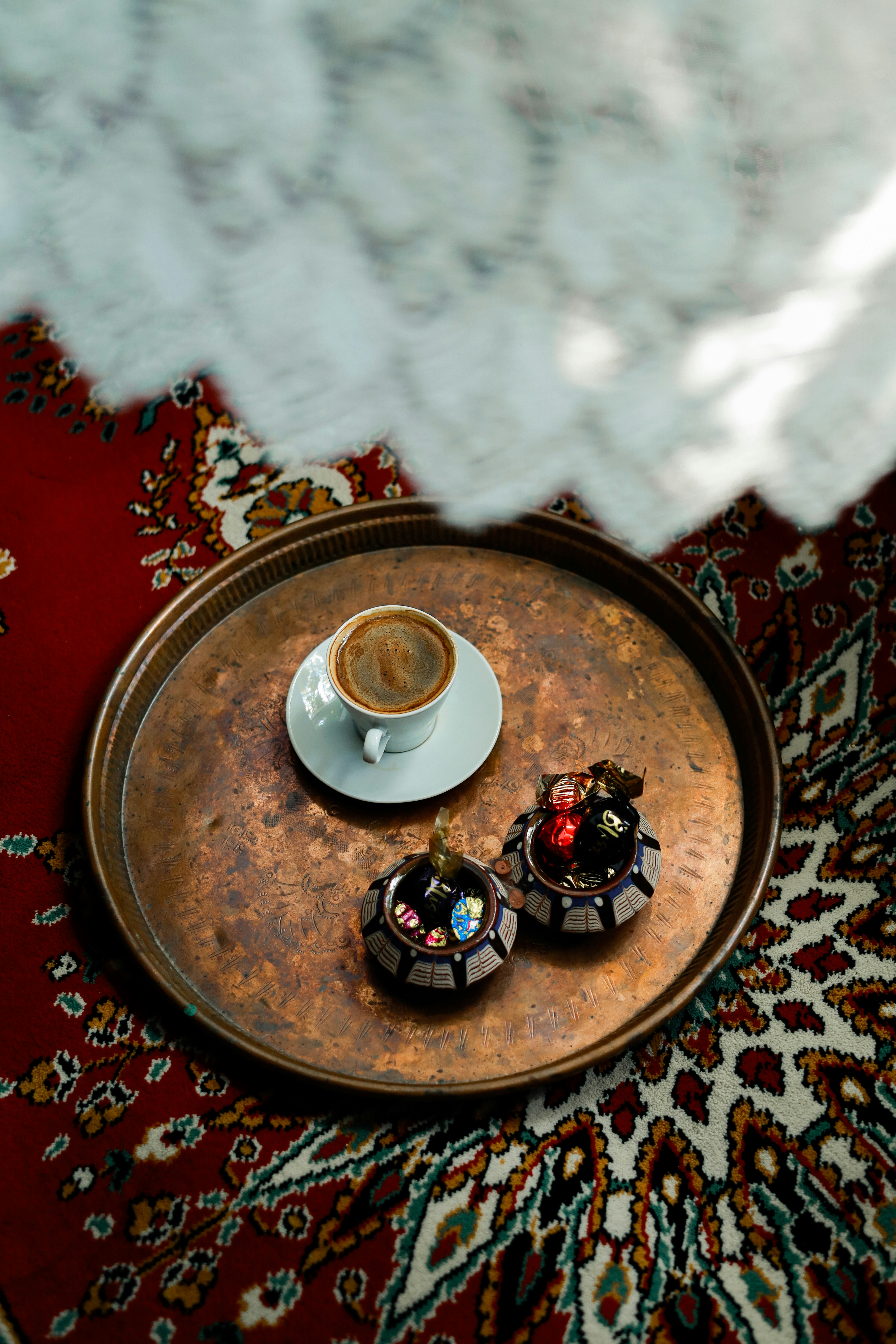 A tray with a cup of coffee on top of it