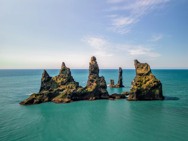 A group of rocks sticking out of the ocean