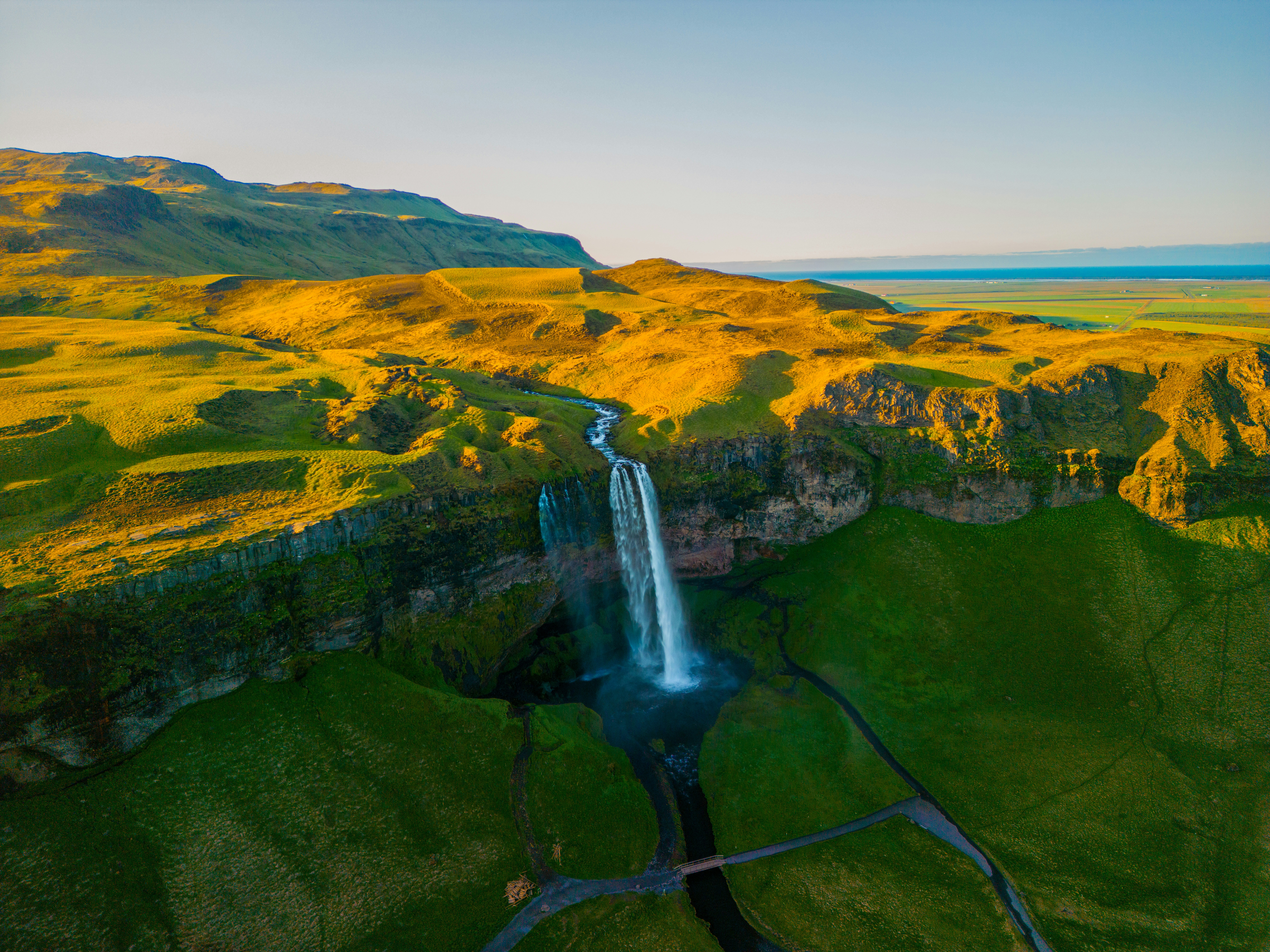 An aerial view of a waterfall in the mountains