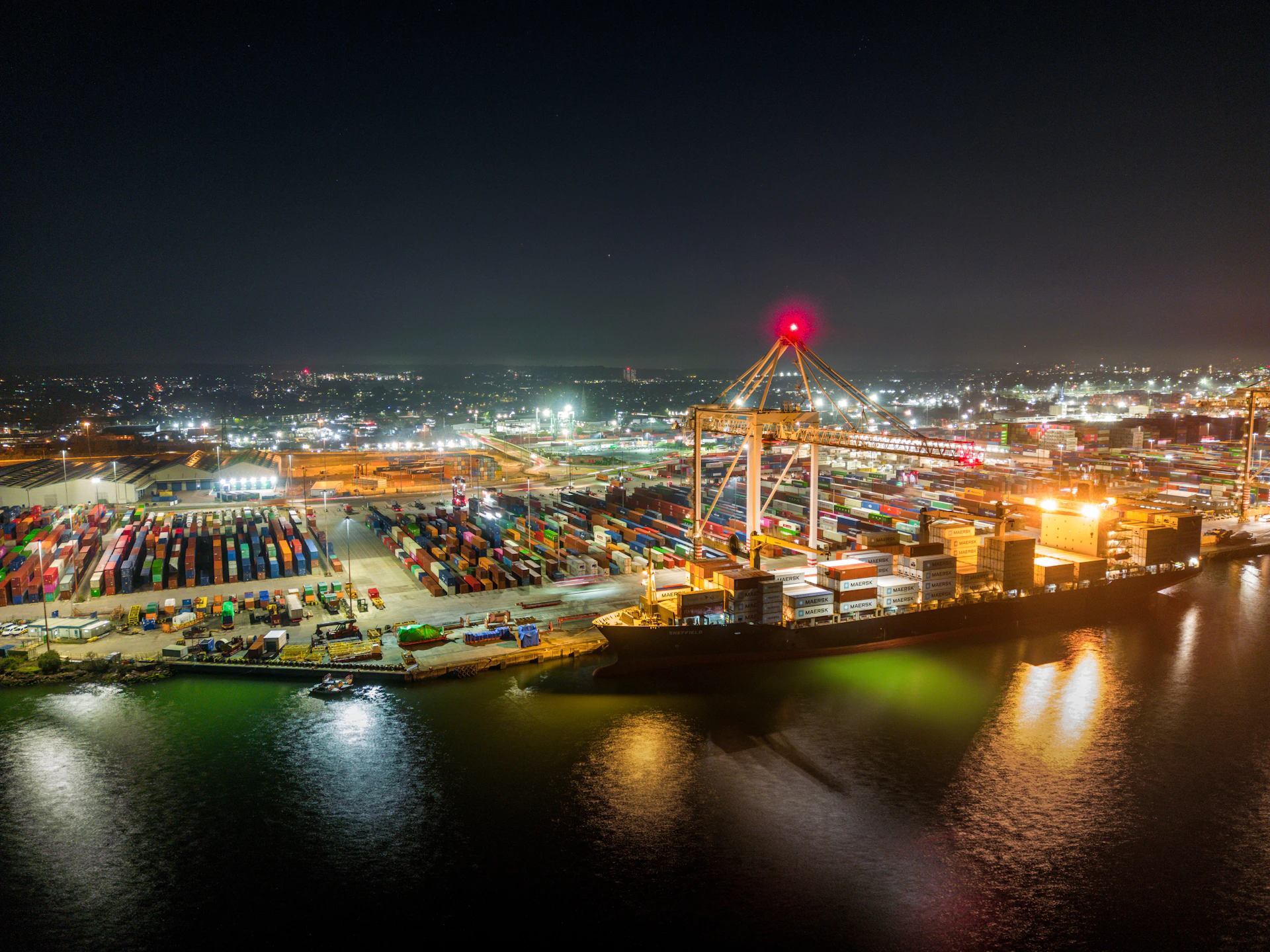 A harbor filled with lots of boats at night