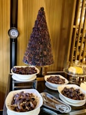 A table topped with bowls of food and a christmas tree