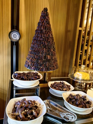 A table topped with bowls of food and a christmas tree