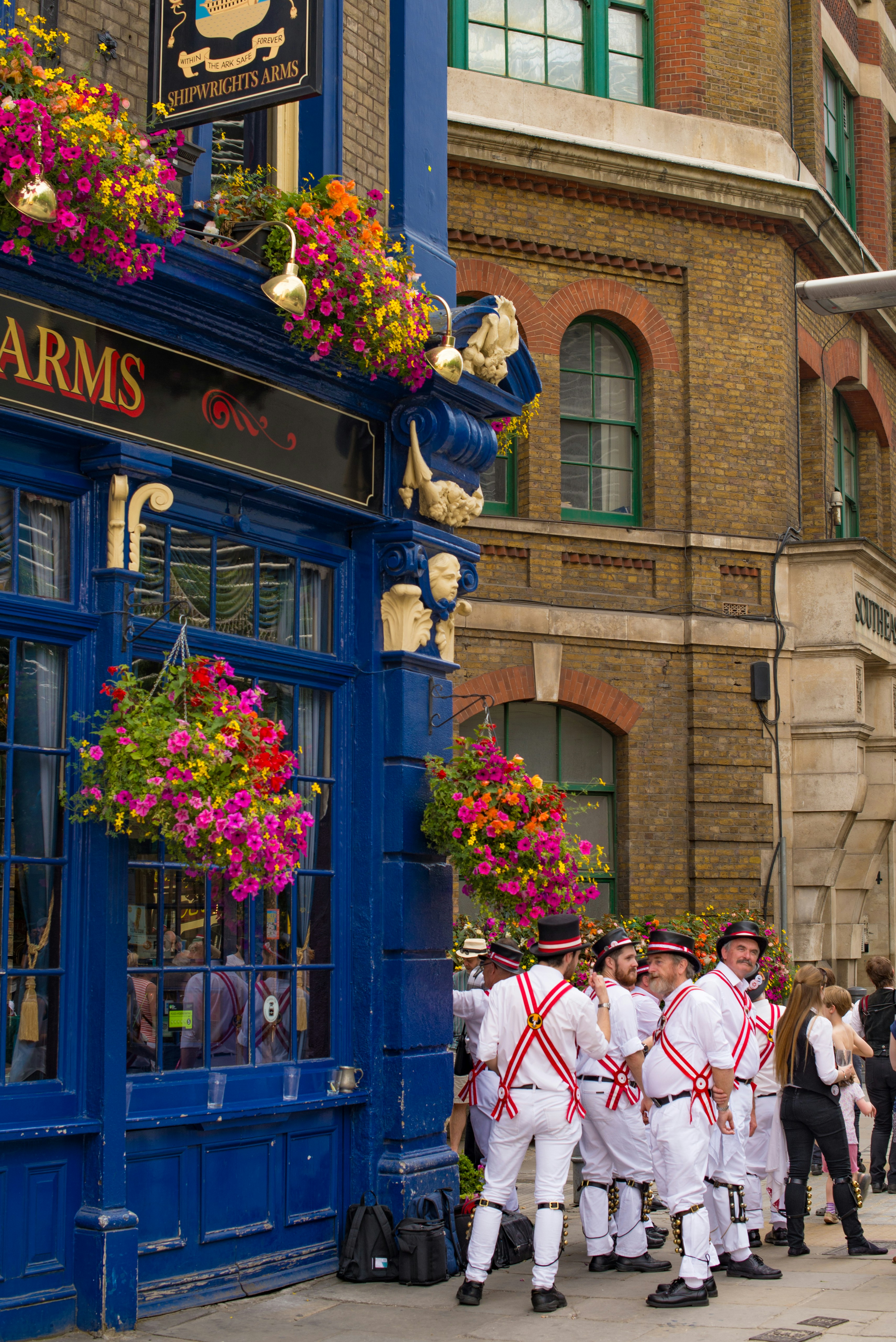A group of men standing in front of a store