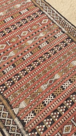 A red and black area rug on the floor