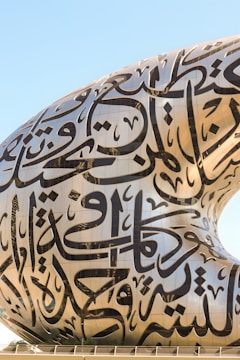 A large sculpture of a whale with arabic writing on it