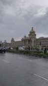 A city street with a large building in the background