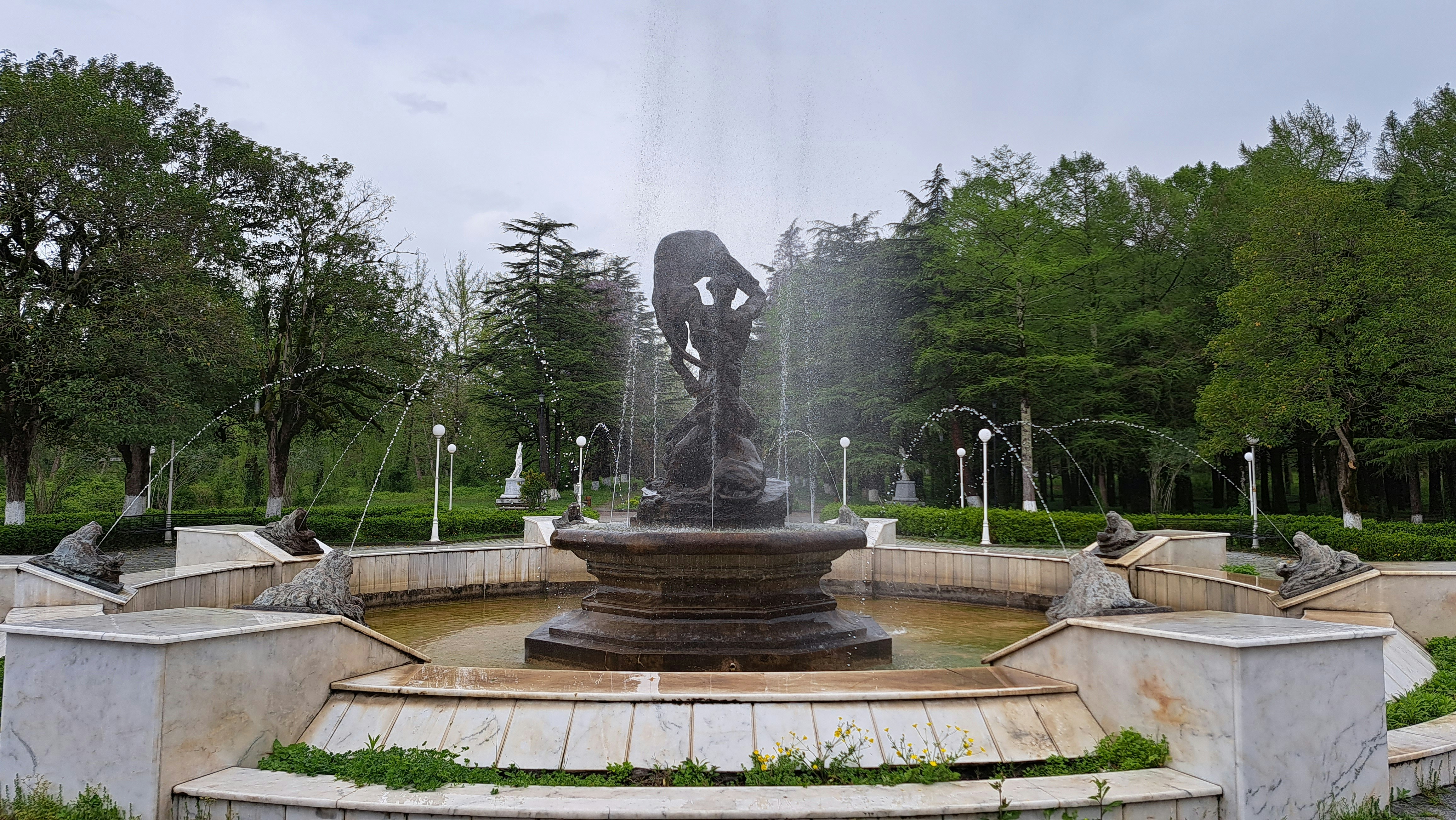 A fountain with a statue in the middle of it