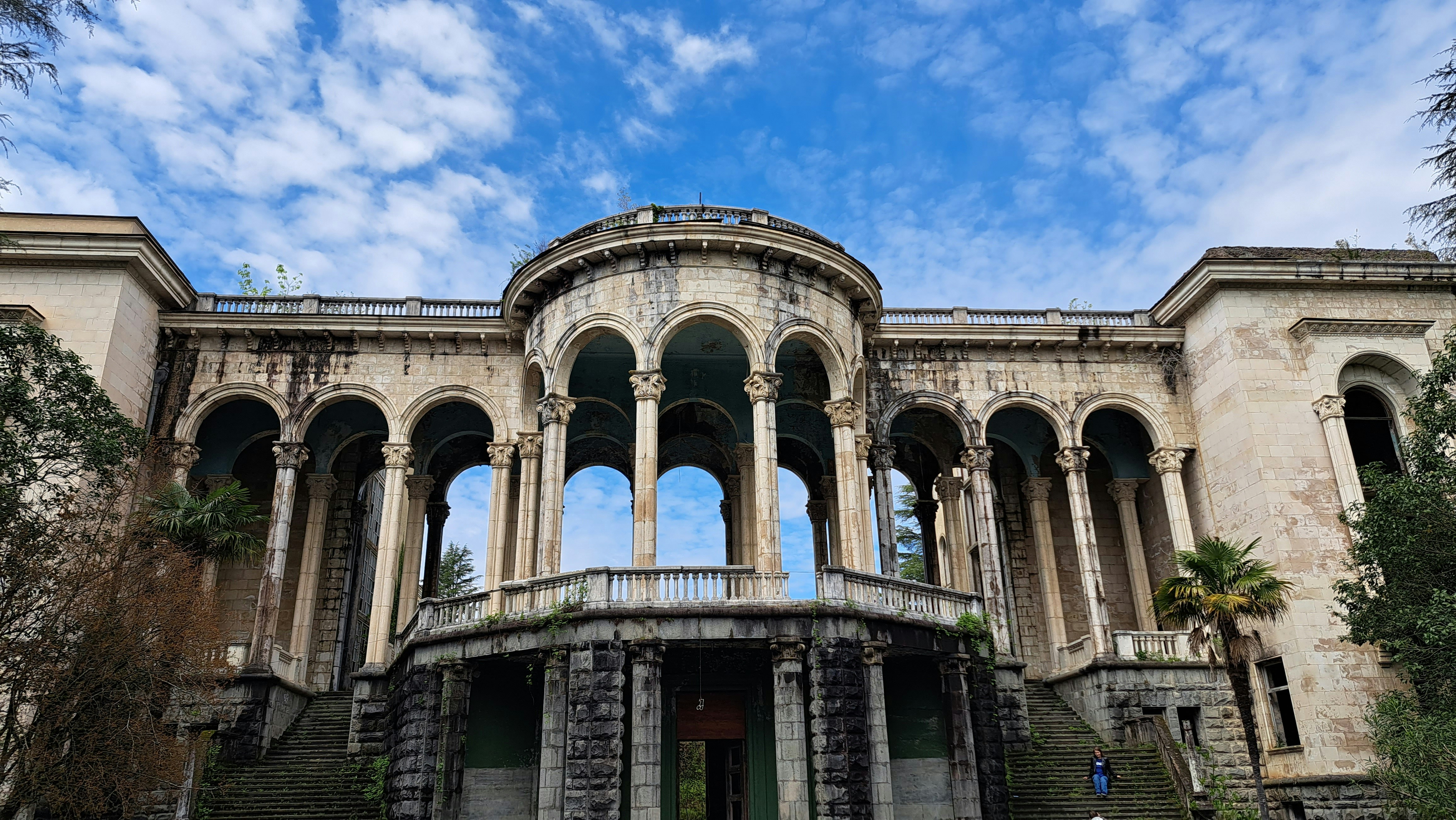 A large building with columns and arches on the front of it