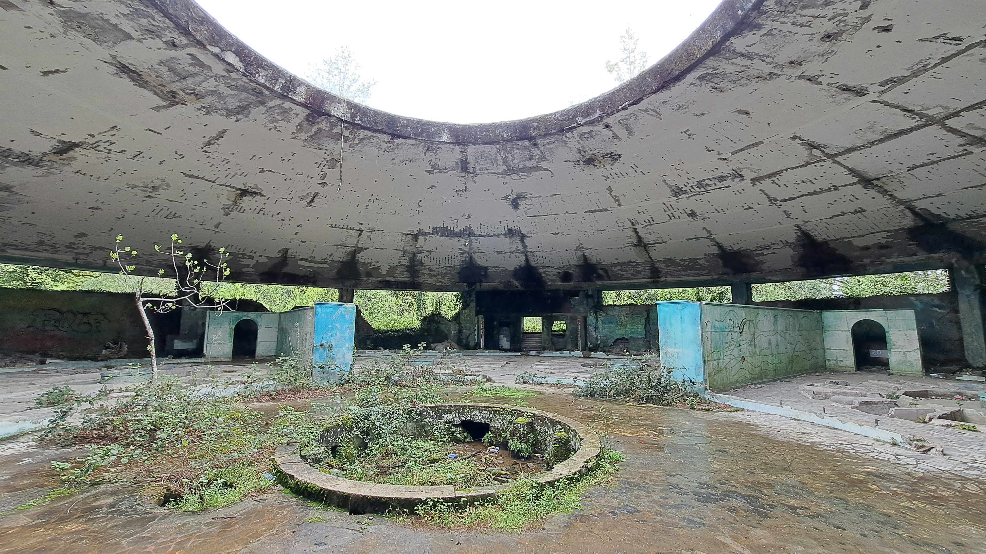 An abandoned building with a round hole in the center