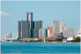 A picture of a city with a lake in front of it
