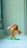 A toy lion is standing on its hind legs