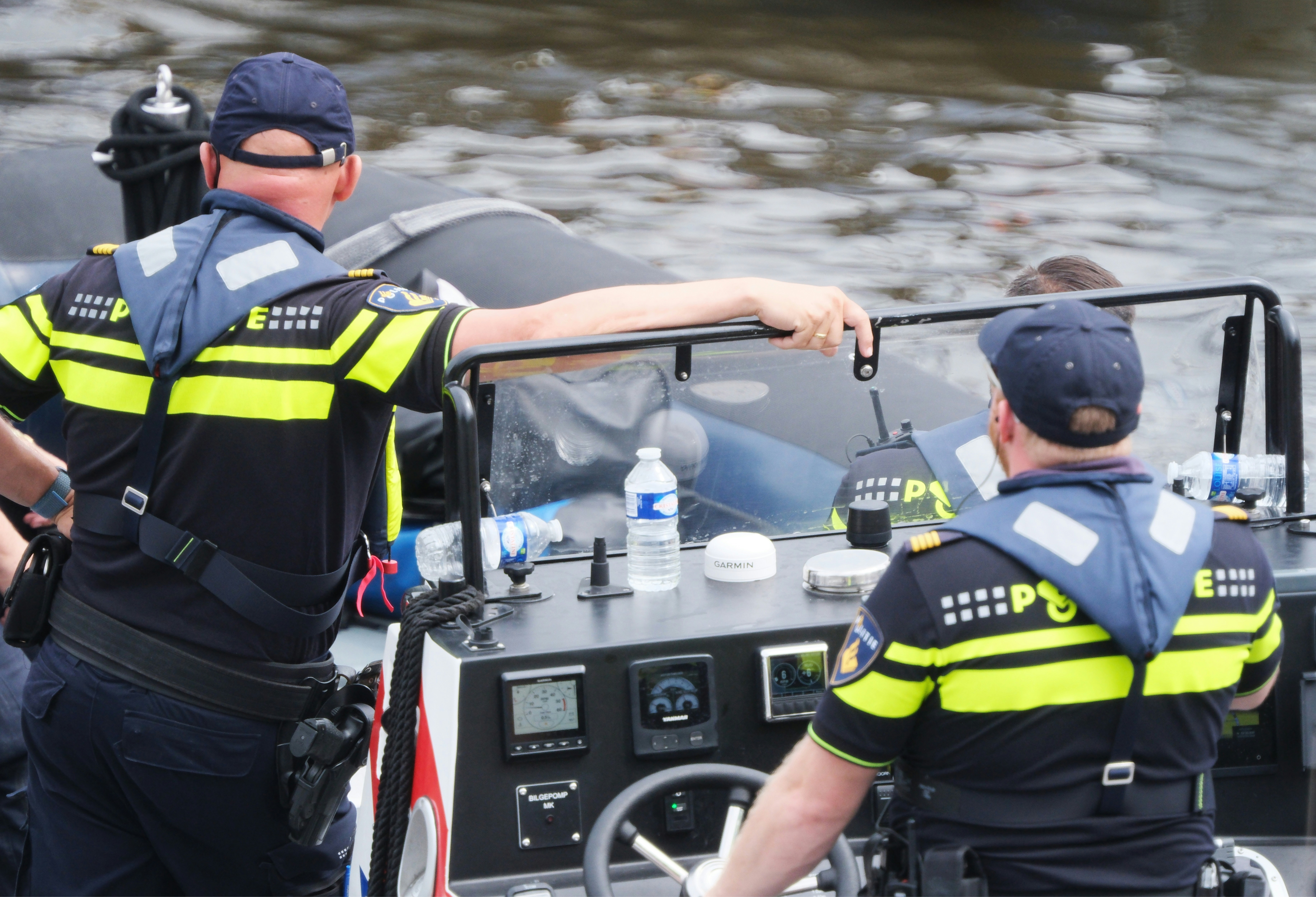 A couple of men standing on top of a boat