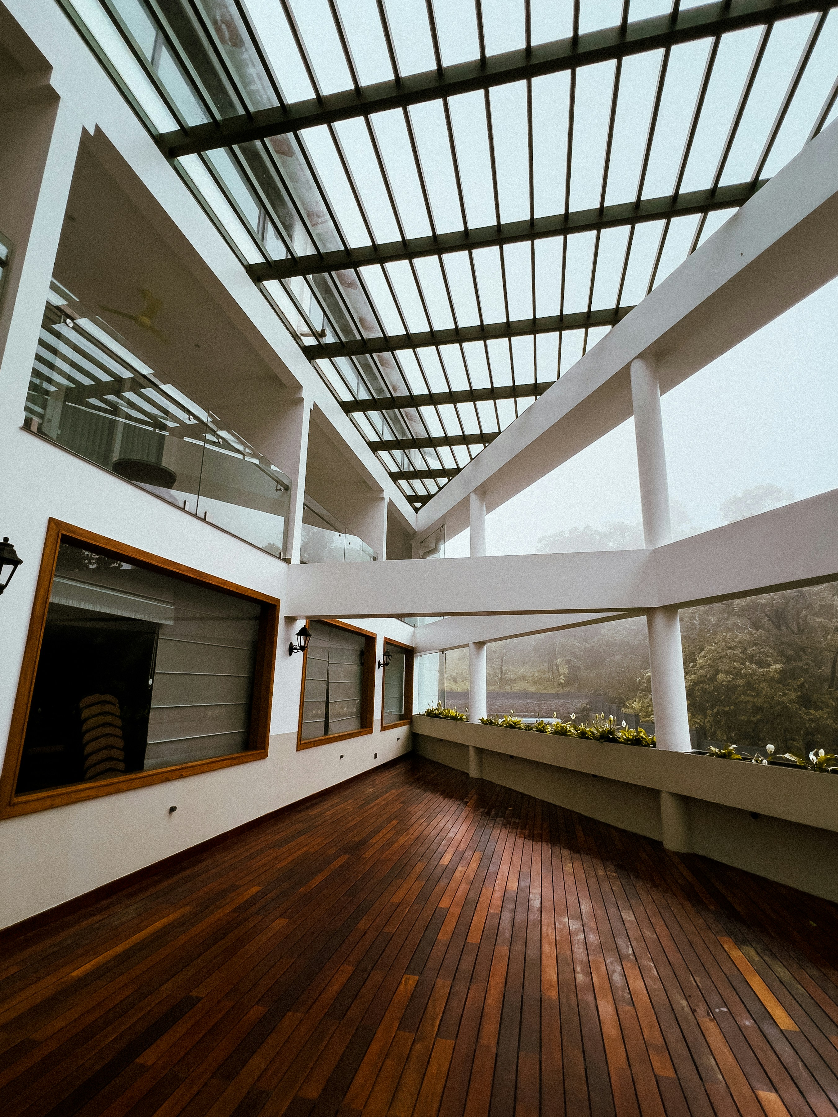 A large room with a wooden floor and a skylight